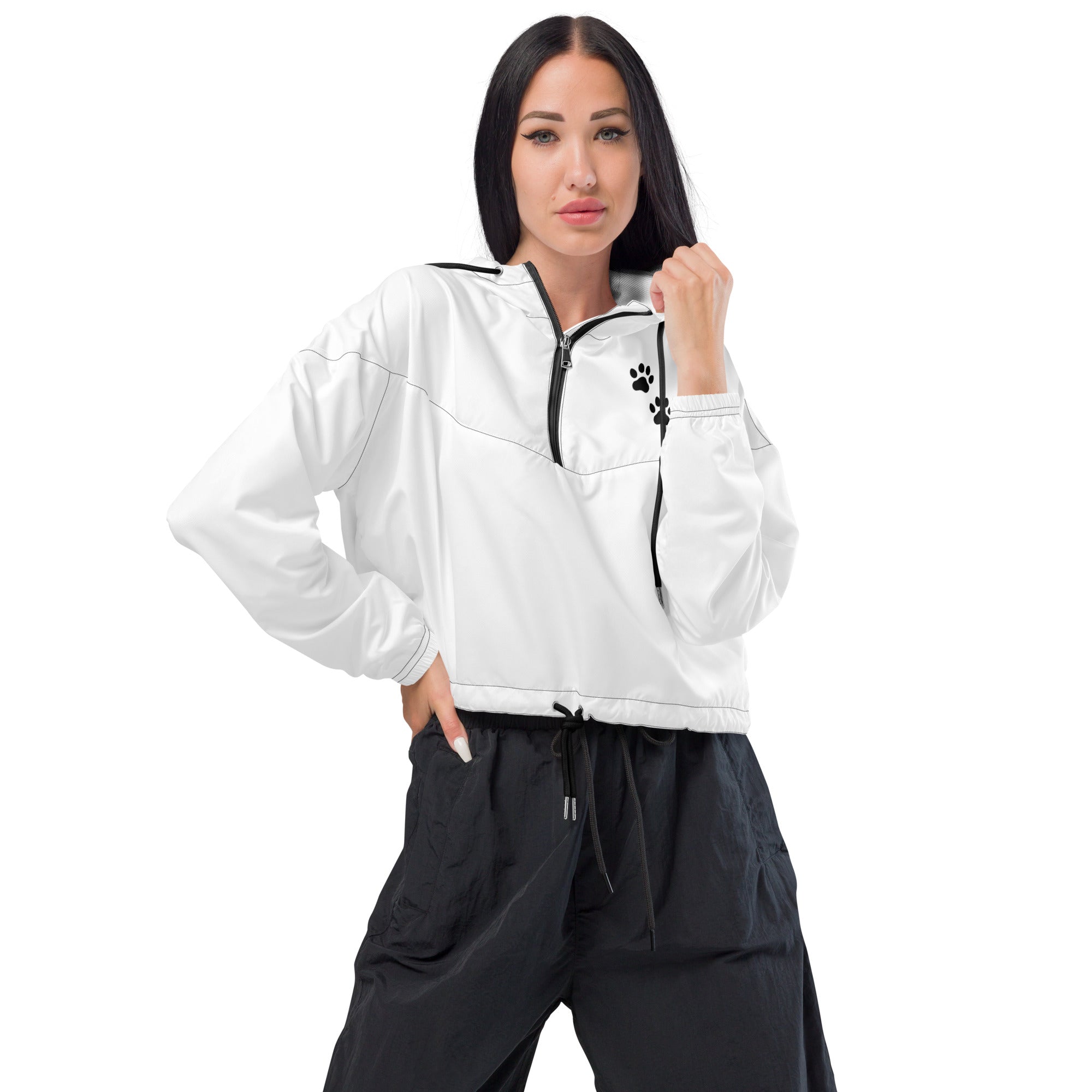Woman wearing a white jacket with a black zipper and black pants on a white background