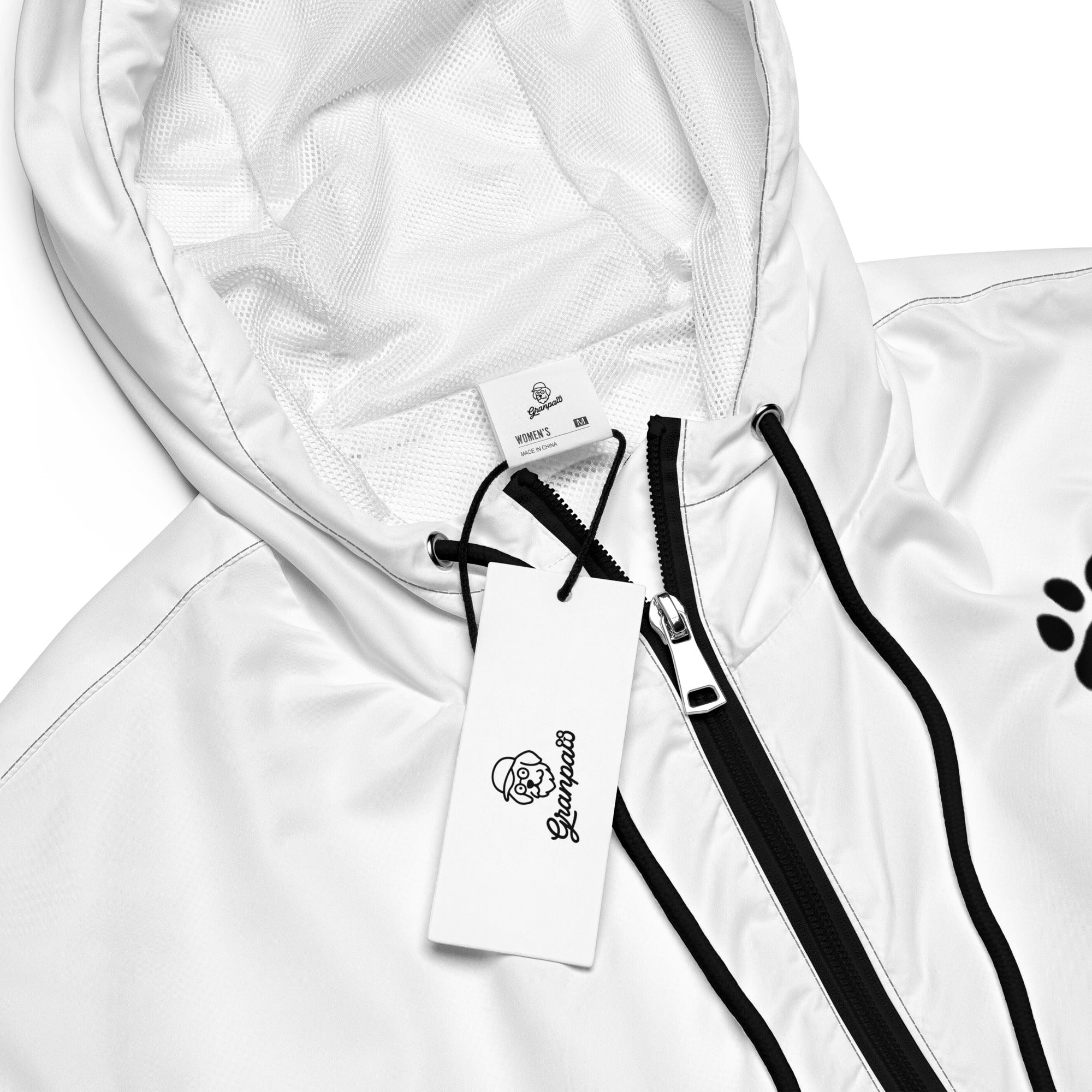 White jacket with black zipper and paw print design on a white background