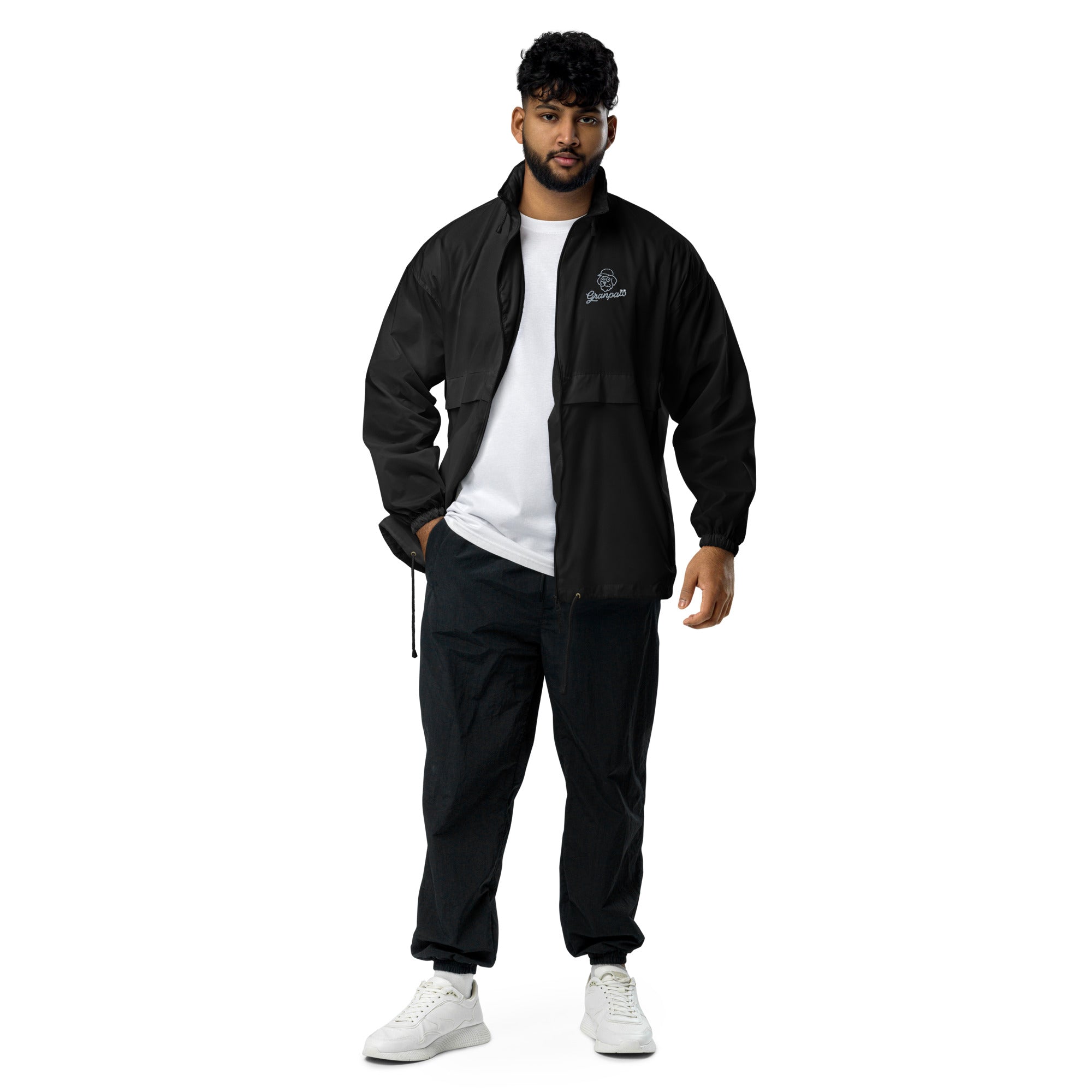 Man wearing a black tracksuit with a white logo on a white background