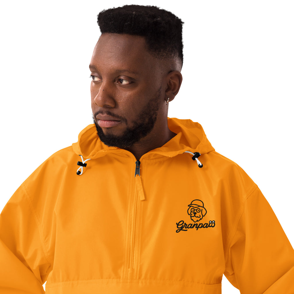 Man wearing a yellow raincoat with a brand logo on a white background