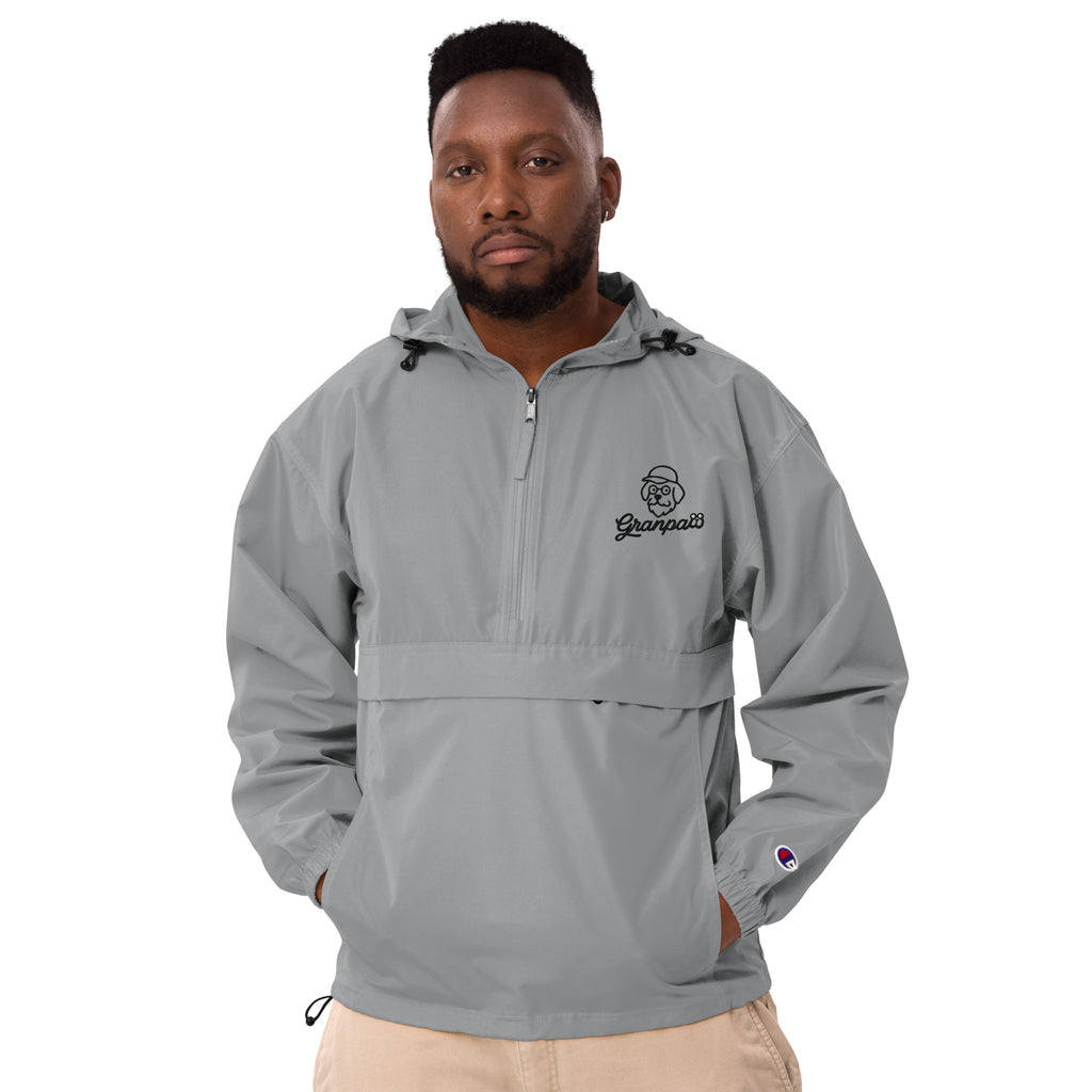 Man wearing a gray pullover with a logo on a white background
