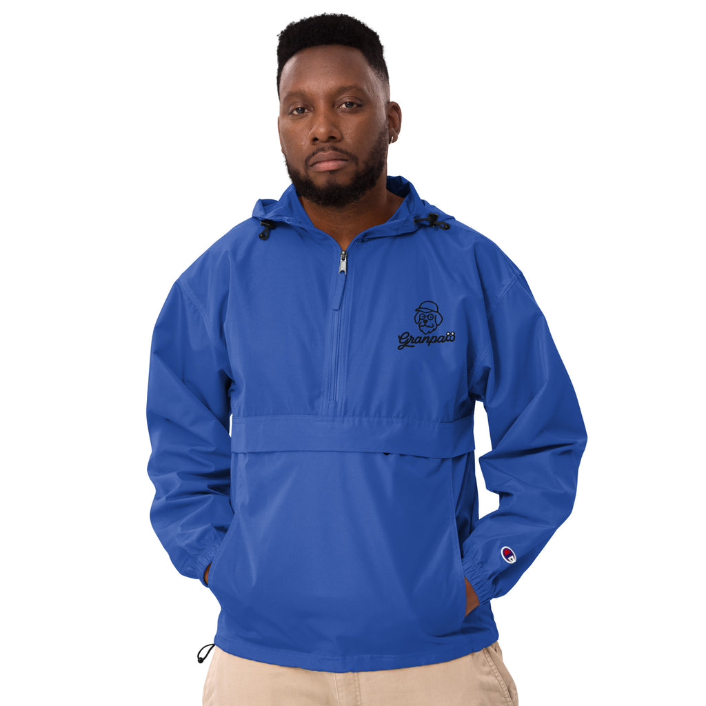 Man wearing a blue pullover with a logo on a white background