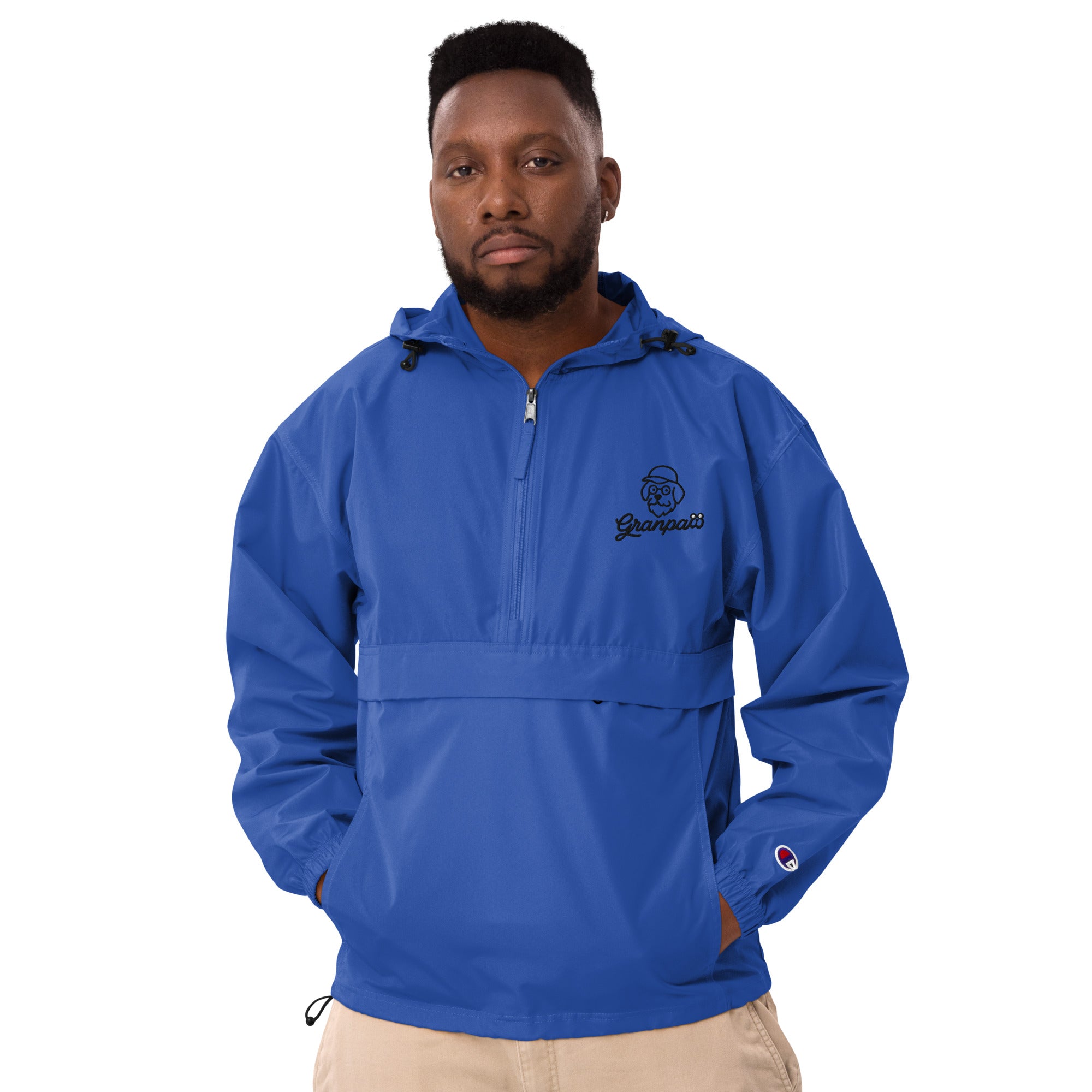 Man wearing a blue pullover with a logo on a white background