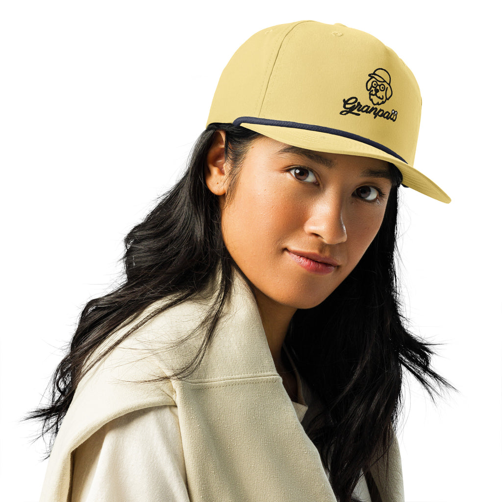 Woman wearing a beige cap with a logo on a white background