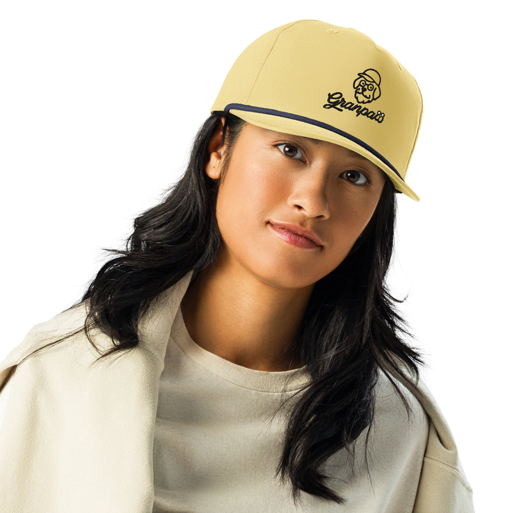 Woman wearing a beige cap with a brand logo on a white background