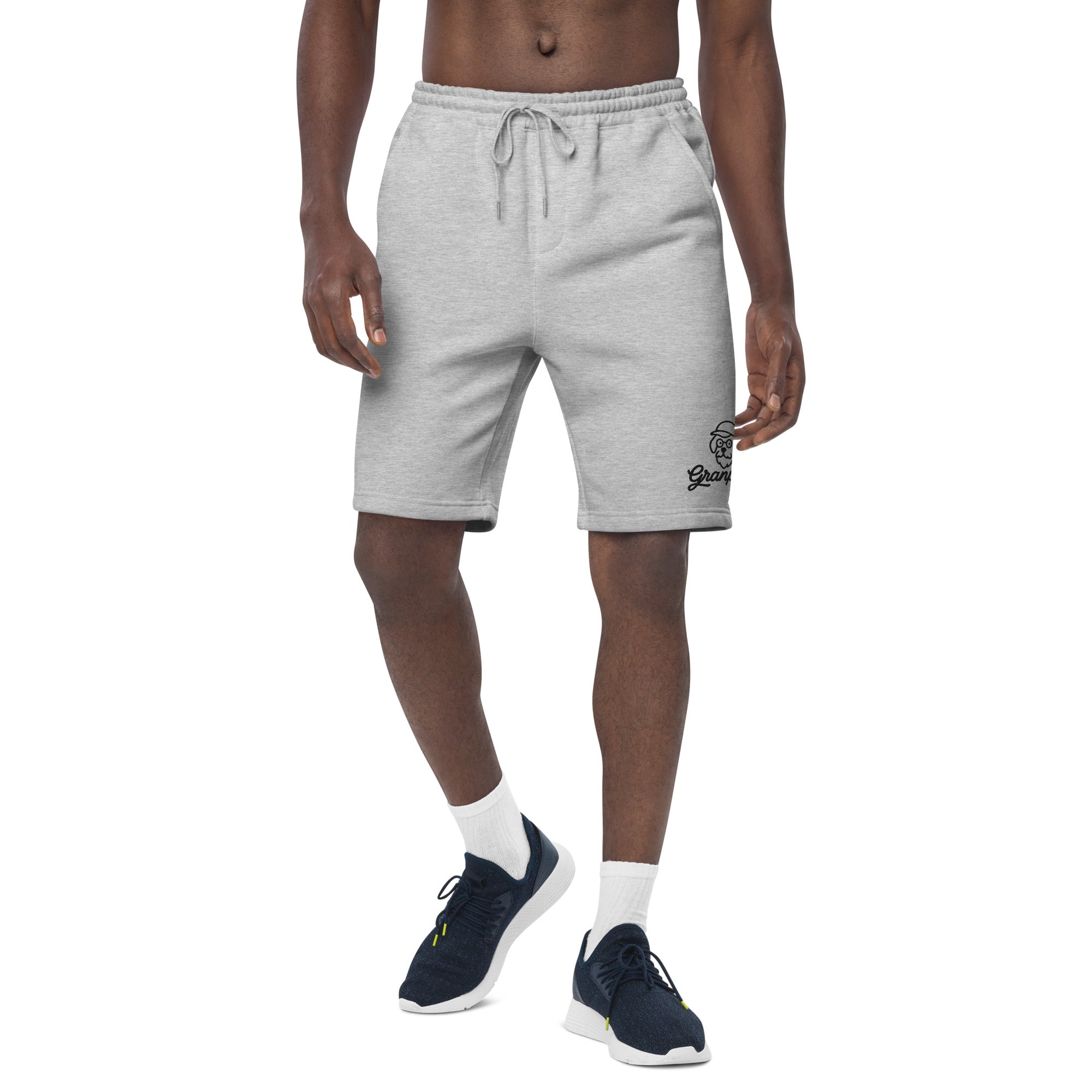 Person wearing gray shorts with a brand logo on a white background