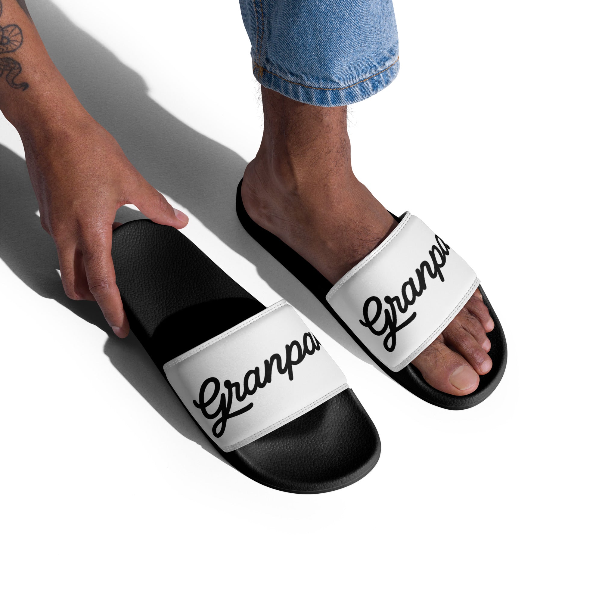 Black and white slides with 'Granpa' text worn by a person on a white background