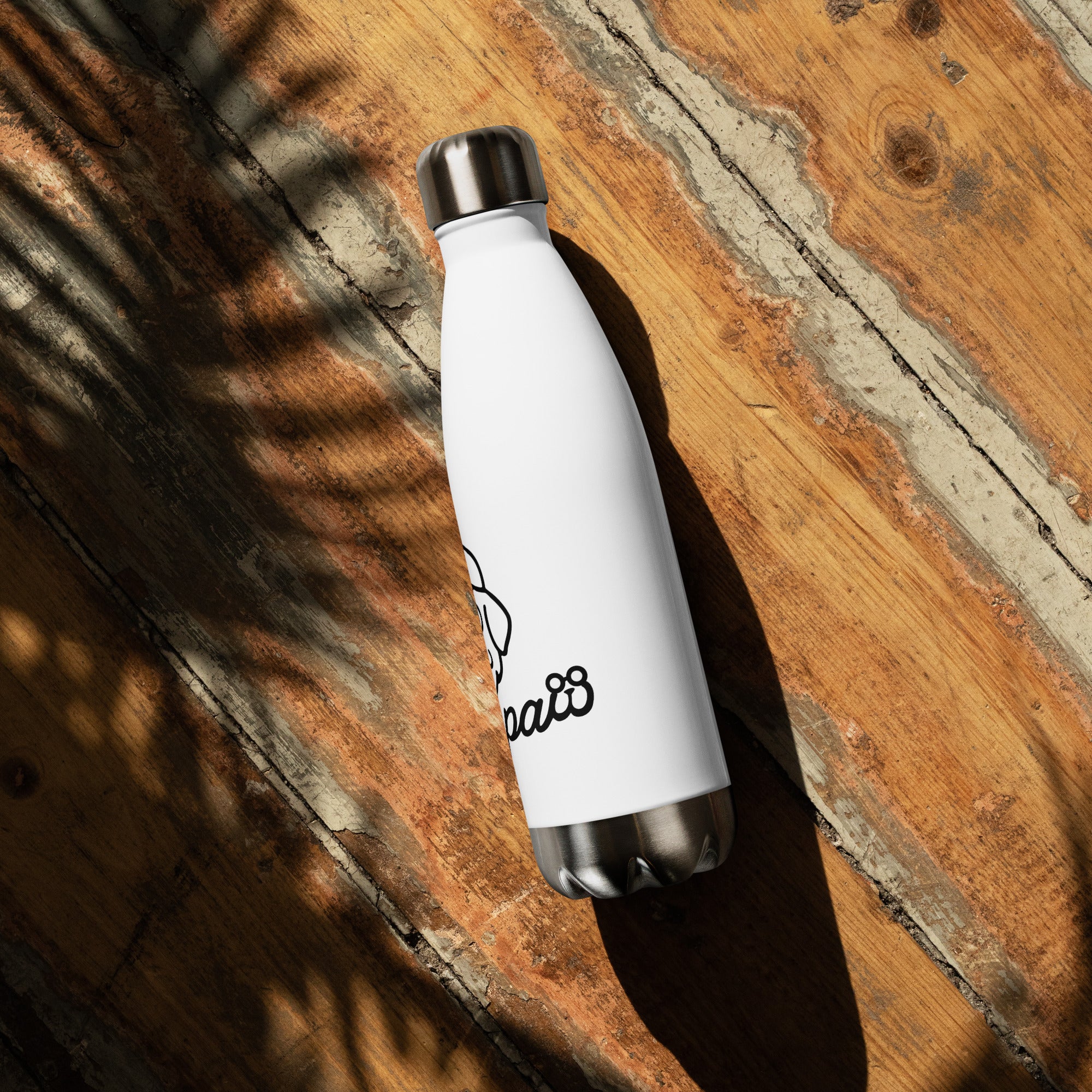 White water bottle with black logo on a wooden surface
