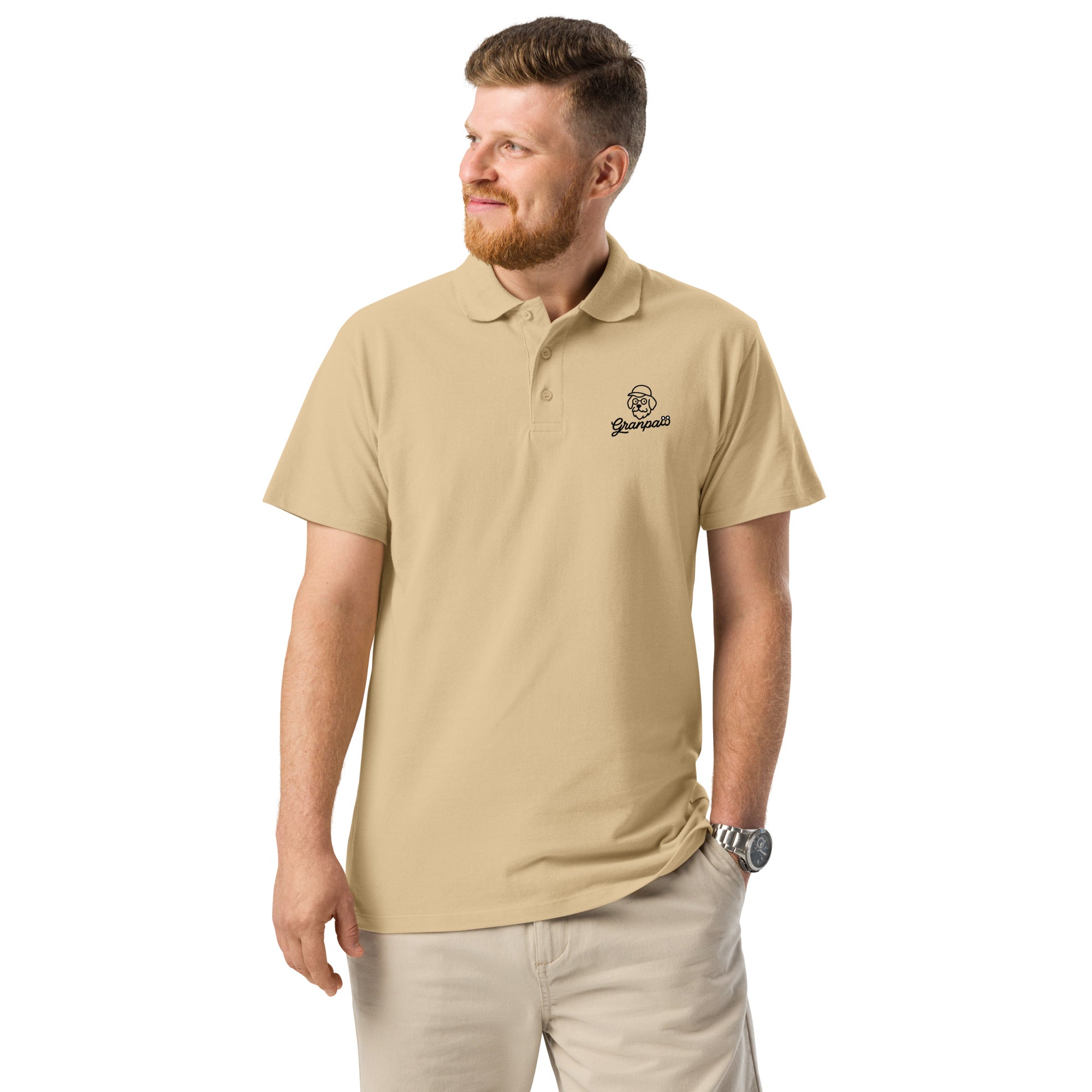 Man wearing a beige polo shirt with a logo on a white background