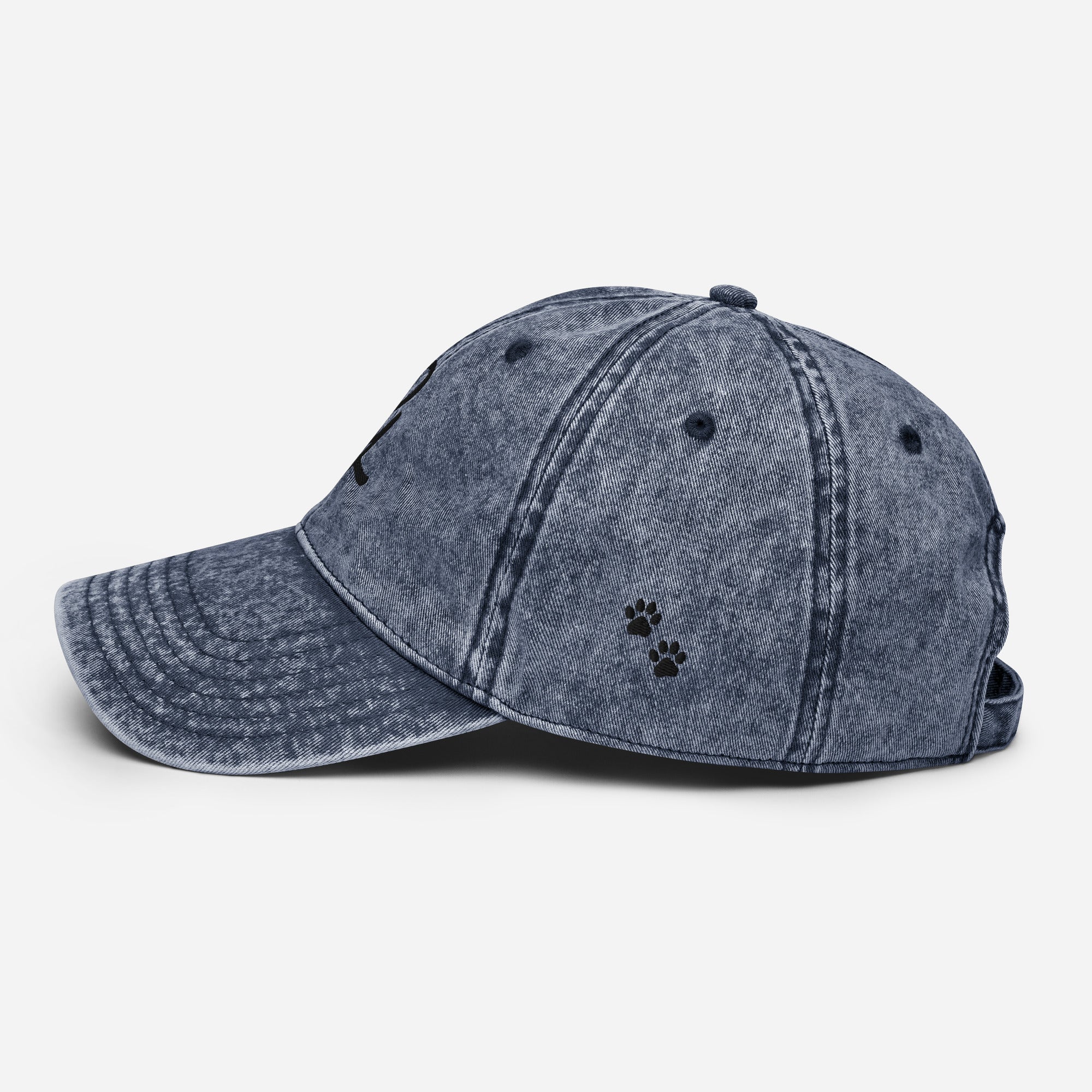 Blue denim cap with a paw print on a white background