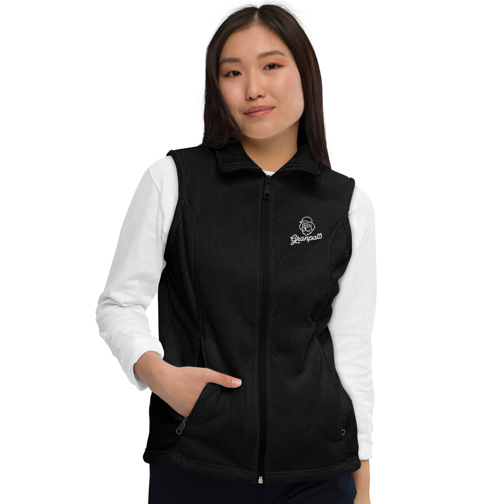 Person wearing a black vest with a logo on a white background
