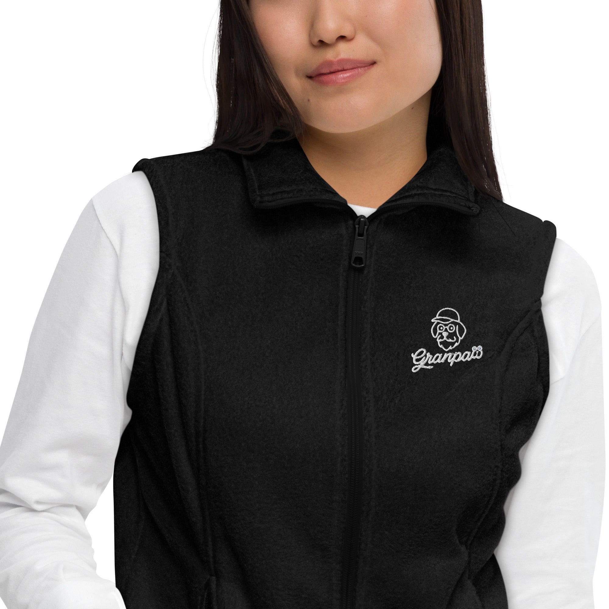 Person wearing a black vest with a logo on a white background