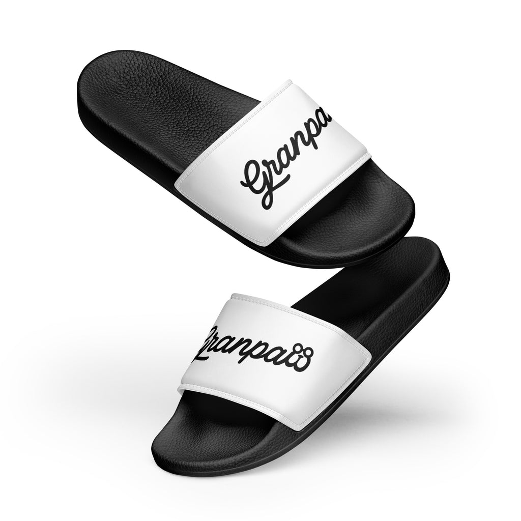 Black slides with white straps displaying 'Granpaw' on a white background