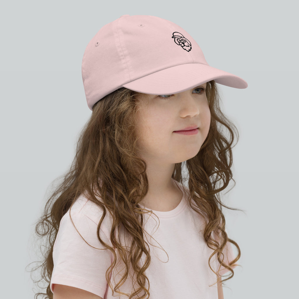 Young girl wearing a pink cap with a logo on a light gray background